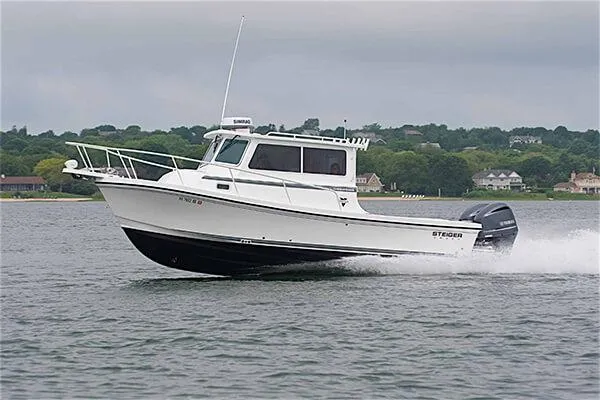 Slide: The Image of 2026 Steiger Craft 28 Miami boat cruising on a lake with scenic shoreline. - 15