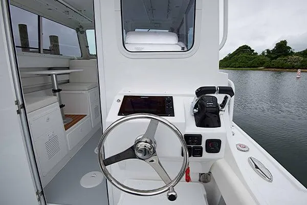 Slide: The Image of 2026 Steiger Craft 28 Miami boat interior with steering wheel and control panel. - 21