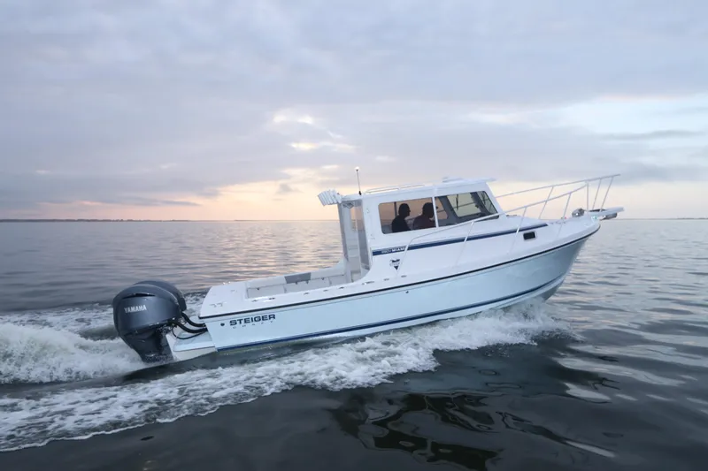 Slide: The Image of 2026 Steiger Craft 28 Miami boat cruising on calm waters at sunset. - 3