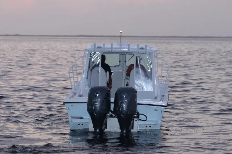 Slide: The Image of 2026 Steiger Craft 28 Miami boat on calm water at sunset. - 5