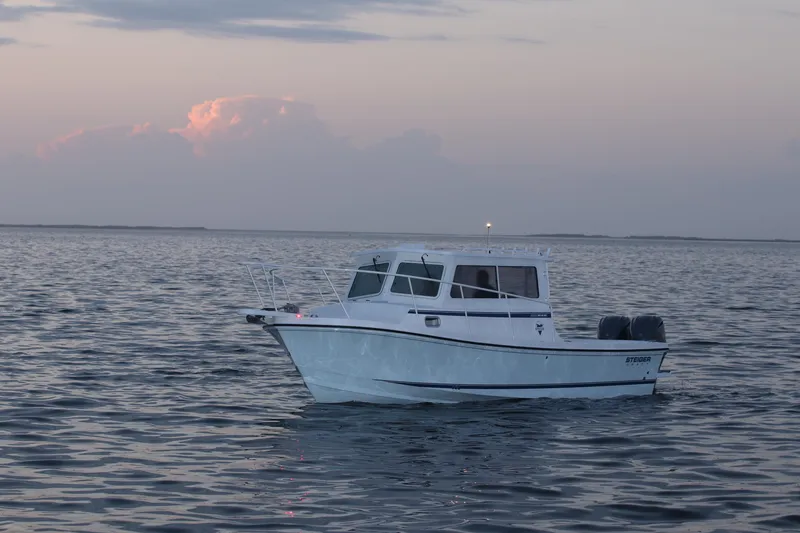 Slide: The Image of 2026 Steiger Craft 28 Miami boat on calm water at sunset. - 6