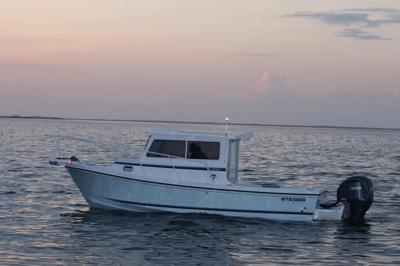 Slide: The Image of 2026 Steiger Craft 28 Miami boat on calm water at sunset. - 7