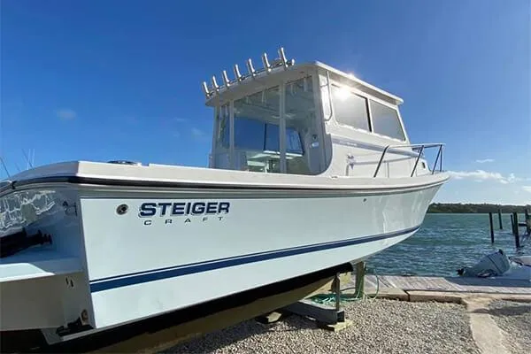 Slide: The Image of 2026 Steiger Craft 28 Miami boat docked by the water under a clear blue sky. - 9
