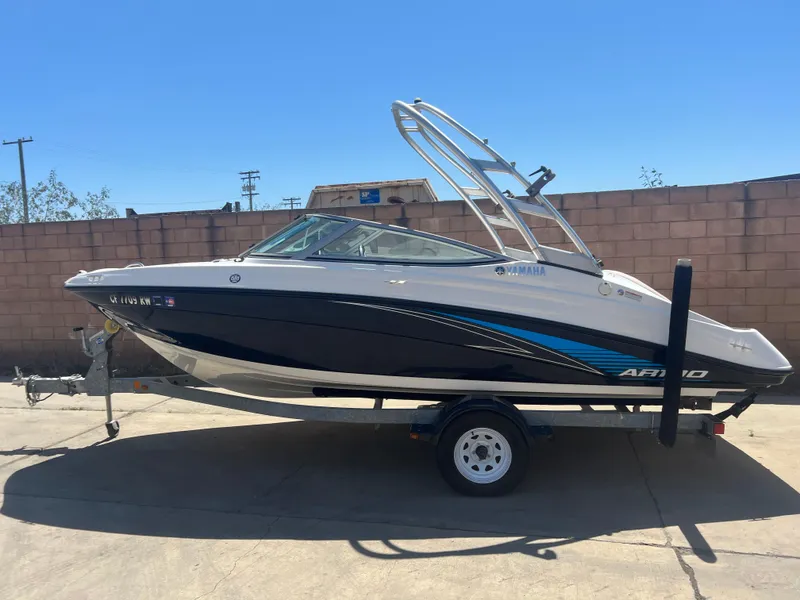 Slide: The Image of 2016 Yamaha AR190 boat on trailer, parked outdoors against a brick wall. - 1