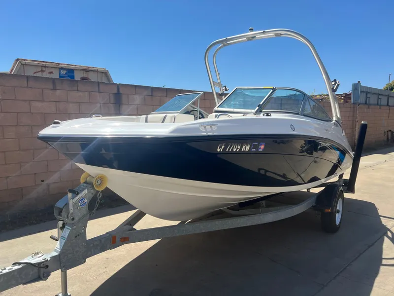 Slide: The Image of 2016 Yamaha AR190 boat on trailer, parked outdoors under clear blue sky. - 2