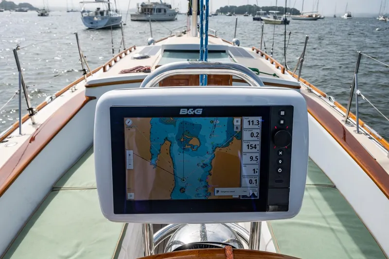 Slide: The Image of Sailing yacht Morris M36 with navigation display, anchored in a scenic harbor. - 19