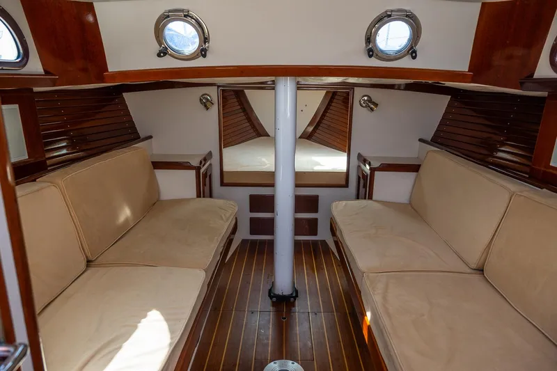 Slide: The Image of Interior of a 2005 Morris M36 sailboat with wooden finishes and beige seating. - 23