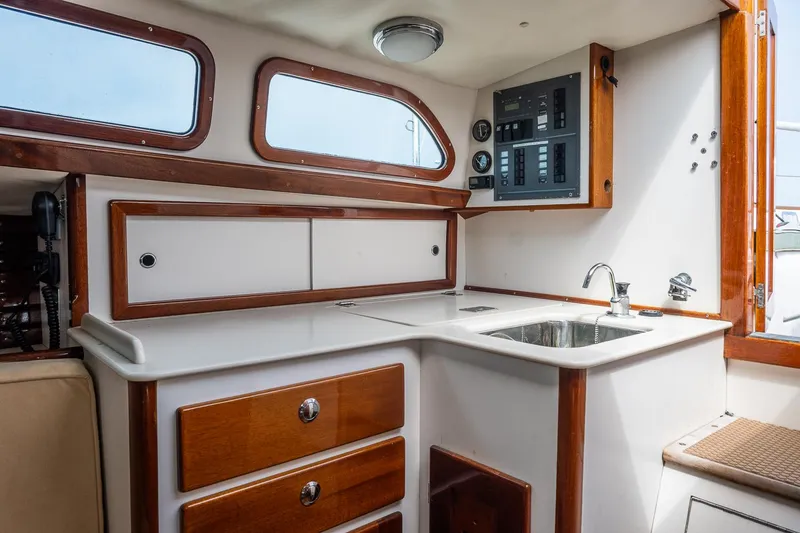 Slide: The Image of Interior of 2005 Morris M36 sailboat galley with wood accents and stainless steel sink. - 25