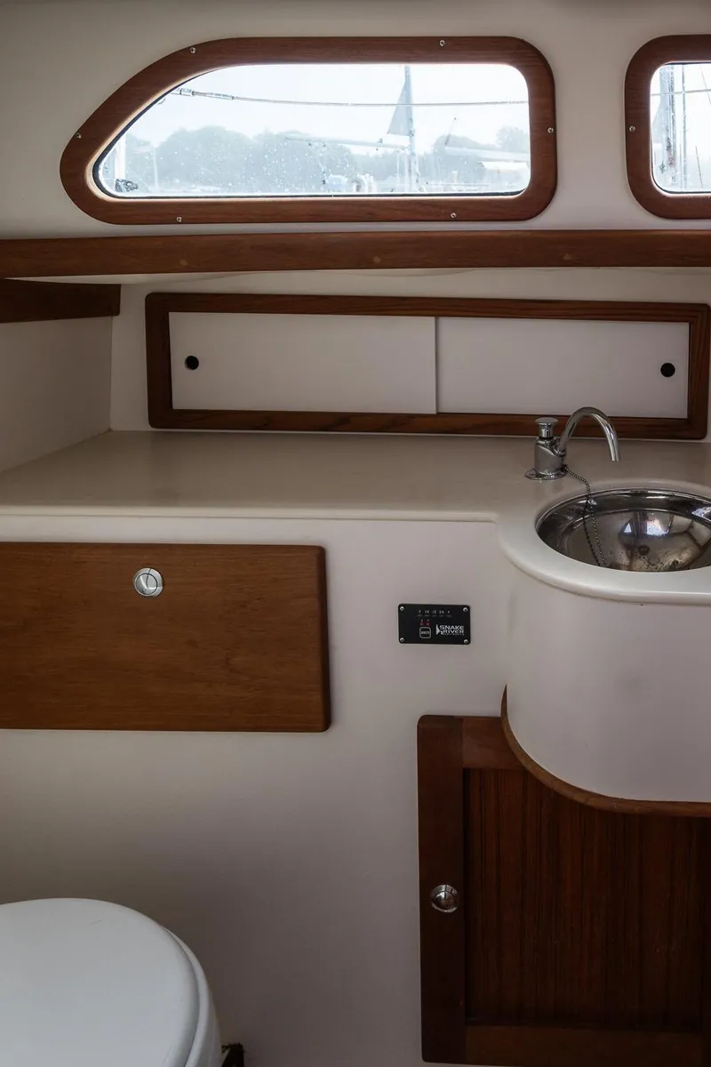 Slide: The Image of Interior of a 2005 Morris M36 yacht bathroom with wooden accents and stainless steel sink. - 26