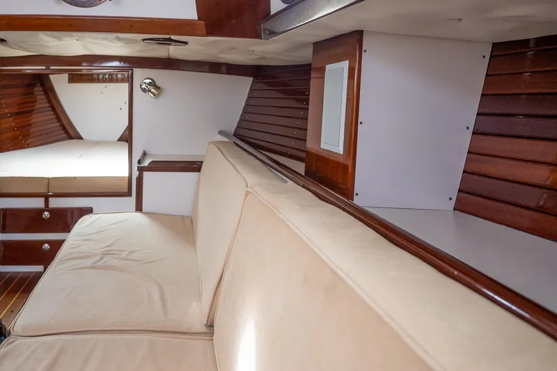 Slide: The Image of Interior of 2005 Morris M36 sailboat with wooden paneling and beige seating. - 27