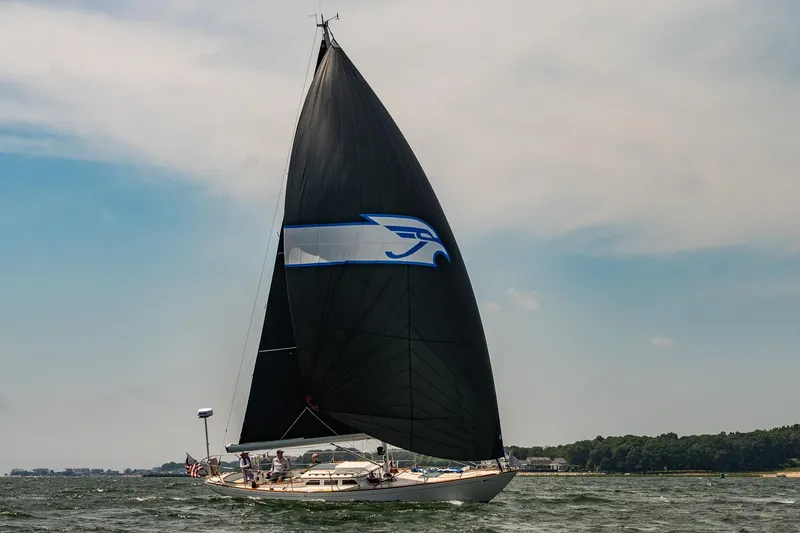 Slide: The Image of Sailing yacht Morris M36 (2005) with black sail on open water, clear sky background. - 35