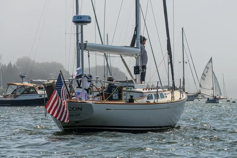 Slide: The Image of Sailboat Morris M36, 2005 model, with American flag, sailing in a misty harbor. - 37