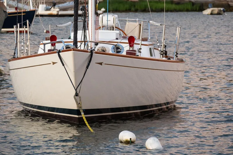 Slide: The Image of Sailboat Morris M36, 2005 model, anchored on calm water with visible buoys. - 4