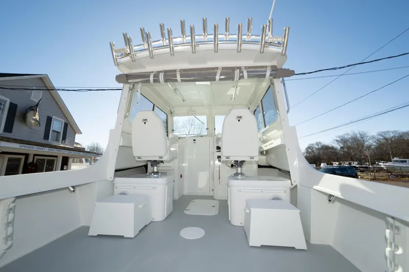 Slide: The Image of 2026 Steiger Craft 28 Fisherman boat interior with seating and rod holders. - 11