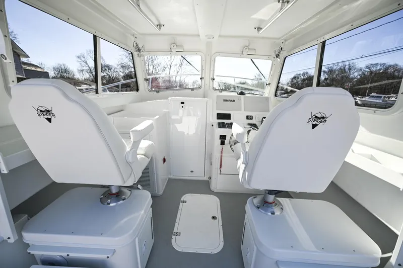 Slide: The Image of Interior of 2026 Steiger Craft 28 Fisherman boat with dual captain chairs and navigation controls. - 12