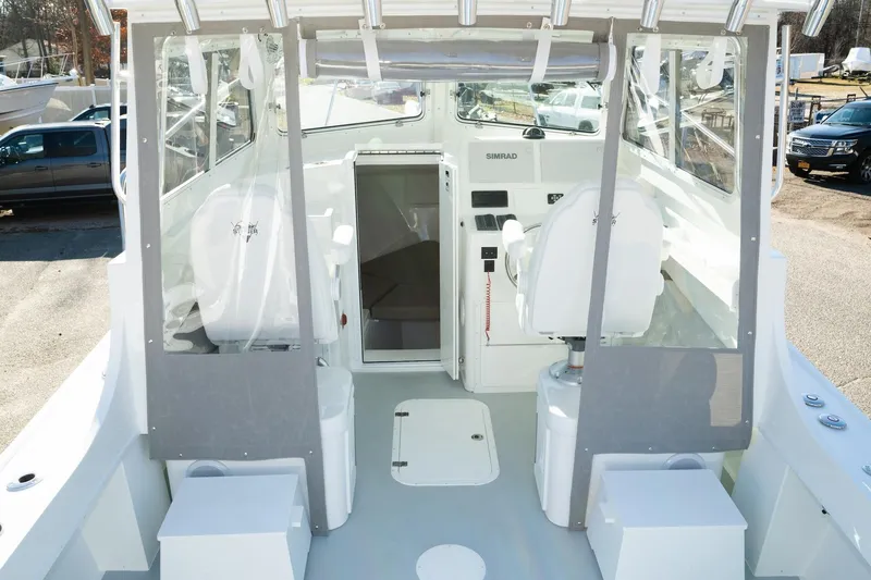 Slide: The Image of 2026 Steiger Craft 28 Fisherman boat interior with helm and seating area. - 3