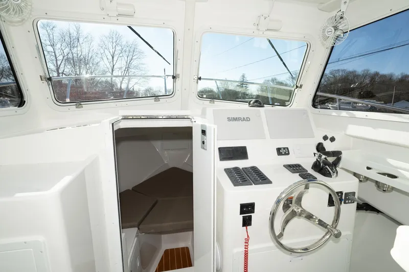 Slide: The Image of 2026 Steiger Craft 28 Fisherman boat interior with steering wheel and navigation equipment. - 4