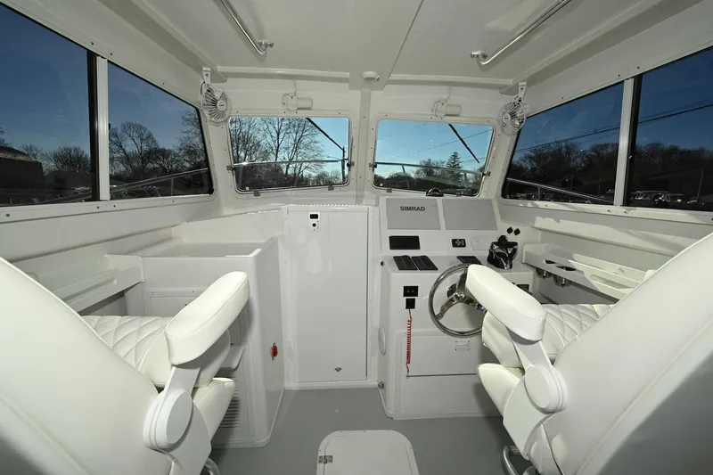 Slide: The Image of 2026 Steiger Craft 28 Fisherman boat interior with modern helm and seating. - 7