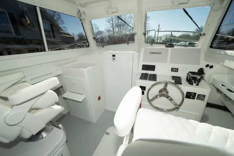 Slide: The Image of 2026 Steiger Craft 28 Fisherman boat interior with steering wheel and navigation equipment. - 8
