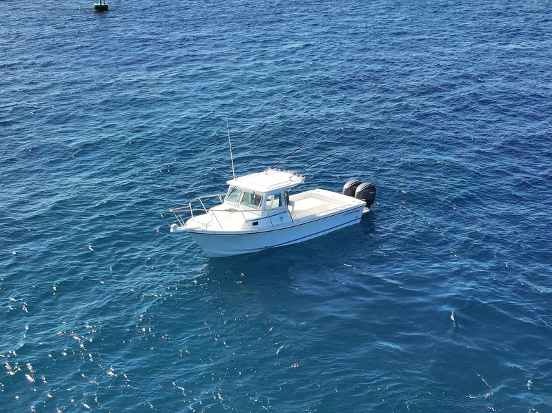 Slide: The Image of 2026 Steiger Craft 28 Hawaii boat on open blue ocean water. - 13