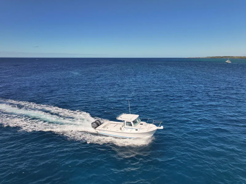 Slide: The Image of 2026 Steiger Craft 28 Hawaii cruising on open blue ocean under clear sky. - 16