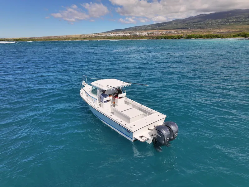 Slide: The Image of 2026 Steiger Craft 28 Hawaii boat on clear blue ocean near scenic coastline. - 3