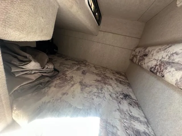 Slide: The Image of Interior cabin of 1997 Sea Ray 240 Sundancer with bedding and storage space. - 10