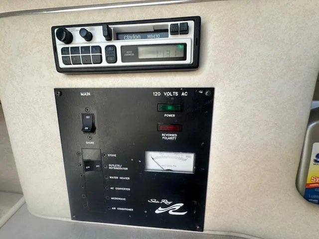 Slide: The Image of Electrical panel and radio system on a 1997 Sea Ray 240 Sundancer boat. - 13