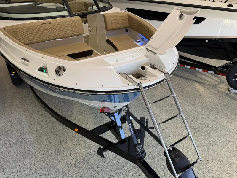 Slide: The Image of 2025 Sea Ray SDX250 Surf boat with open bow and ladder on display. - 16