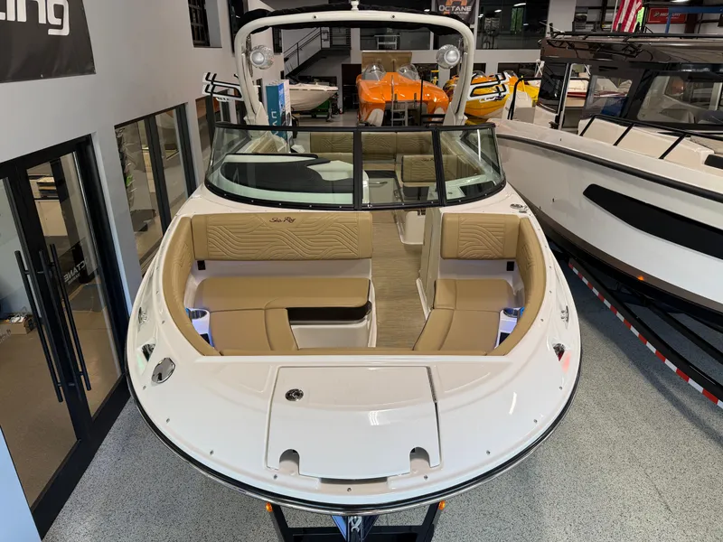 Slide: The Image of 2025 Sea Ray SDX250 Surf boat with spacious seating in showroom. - 17