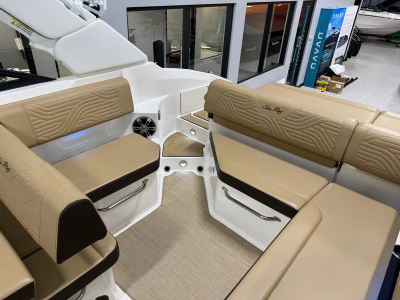 Slide: The Image of 2025 Sea Ray SDX250 Surf boat interior with beige seating and modern design. - 24