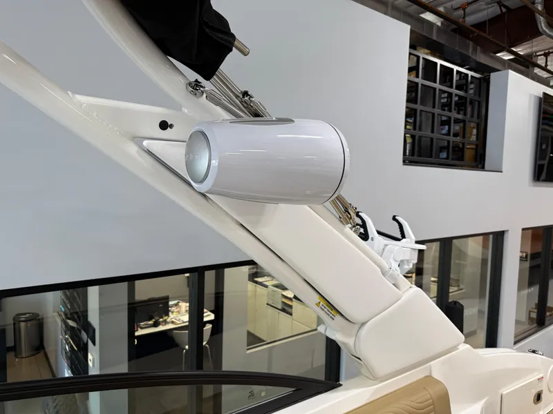 Slide: The Image of 2025 Sea Ray SDX250 Surf boat with sleek white speaker system. - 25