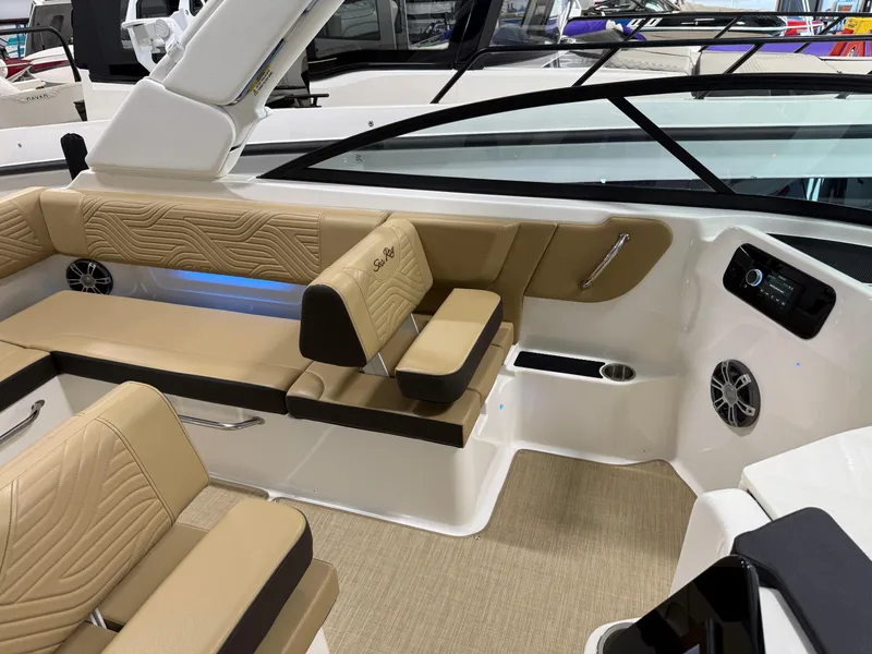 Slide: The Image of 2025 Sea Ray SDX250 Surf boat interior with tan seating and modern design. - 26