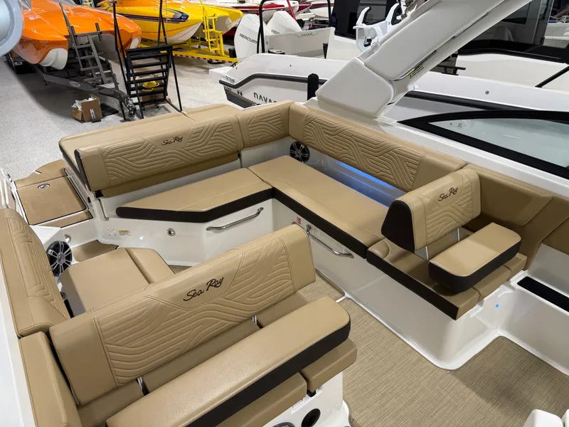 Slide: The Image of 2025 Sea Ray SDX250 Surf boat interior with tan seating and modern design. - 27