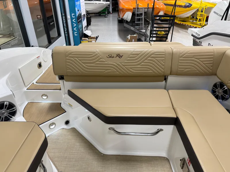 Slide: The Image of 2025 Sea Ray SDX250 Surf boat interior with tan seating and modern design. - 28