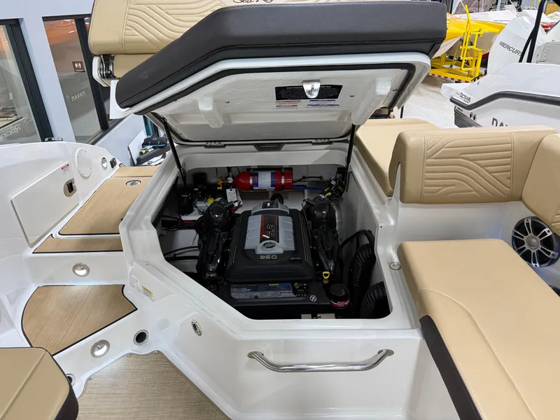 Slide: The Image of 2025 Sea Ray SDX250 Surf boat engine compartment with seating and storage. - 29