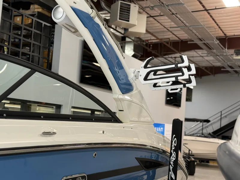 Slide: The Image of 2025 Sea Ray SDX250 Surf boat with sleek design and advanced features in showroom. - 3