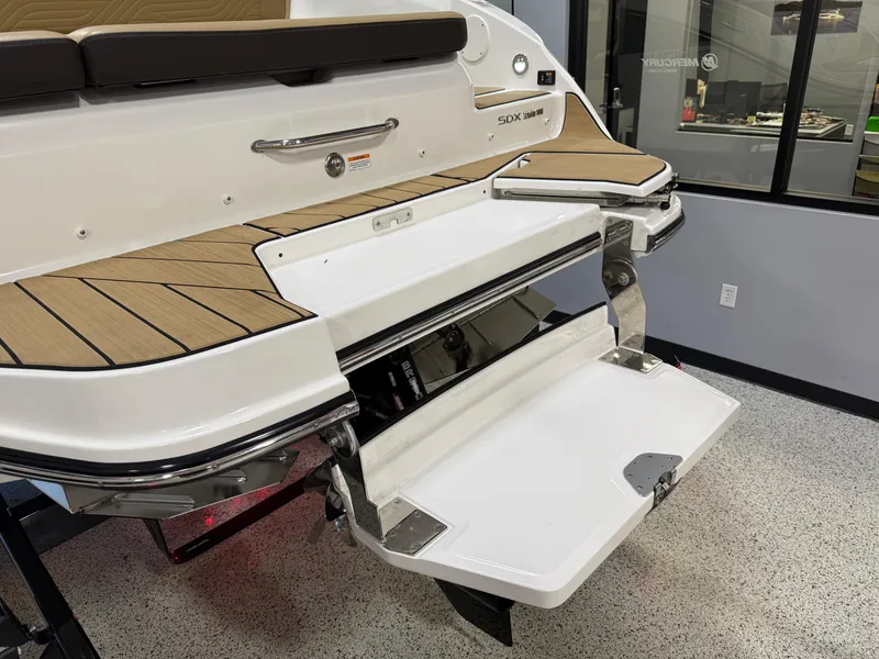 Slide: The Image of 2025 Sea Ray SDX250 Surf boat with extended swim platform in showroom. - 34