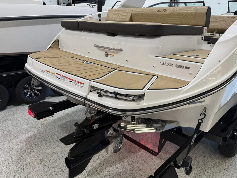 Slide: The Image of 2025 Sea Ray SDX250 Surf boat, rear view with teak swim platform and seating. - 35