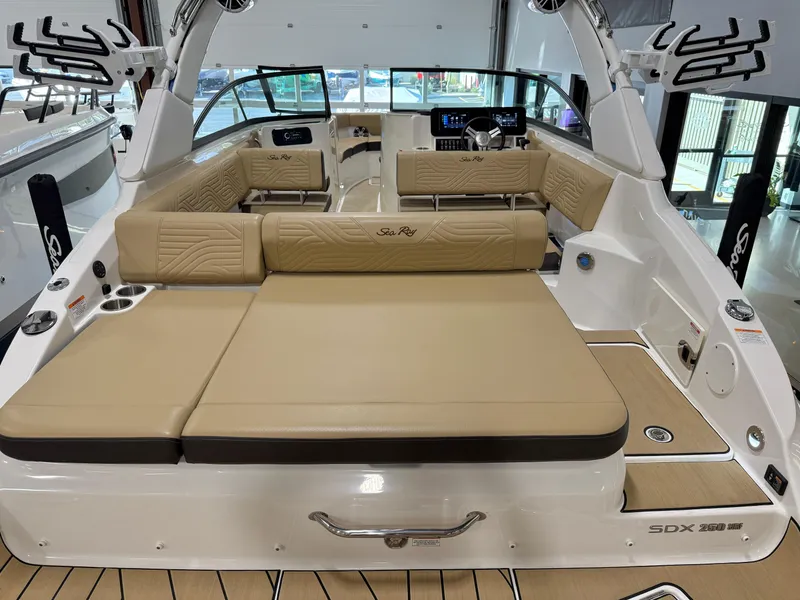 Slide: The Image of 2025 Sea Ray SDX250 Surf boat interior with tan seating and modern dashboard. - 38