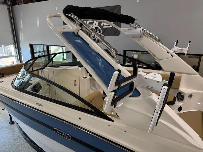 Slide: The Image of 2025 Sea Ray SDX250 Surf boat with sleek design and modern features in showroom. - 4