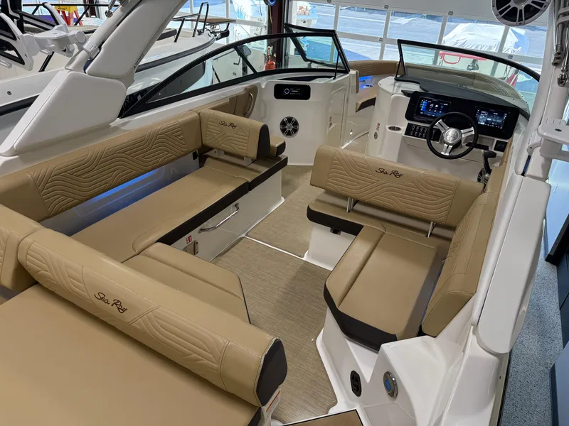 Slide: The Image of 2025 Sea Ray SDX250 Surf boat interior with tan seating and modern dashboard. - 41