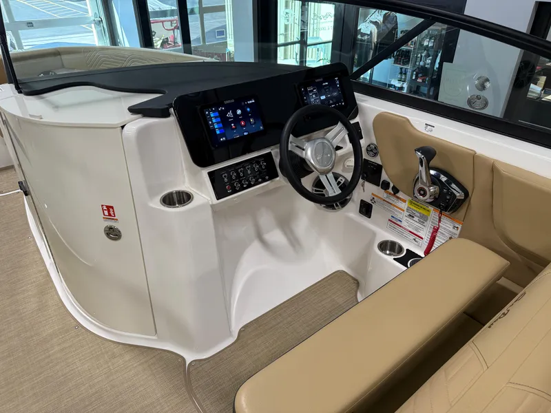 Slide: The Image of 2025 Sea Ray SDX250 Surf boat interior with modern dashboard and steering wheel. - 44