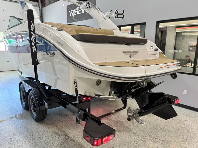 Slide: The Image of 2025 Sea Ray SDX250 Surf boat on trailer in showroom. - 7