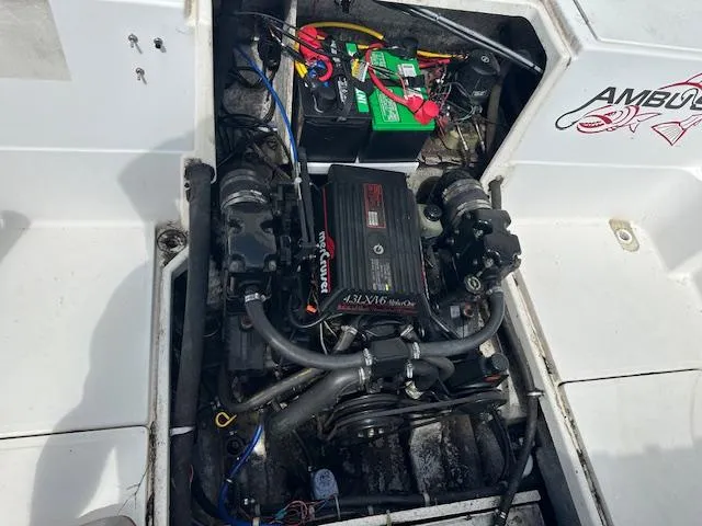 Slide: The Image of Engine compartment of a 1995 Bayliner Trophy boat with visible battery and wiring. - 12