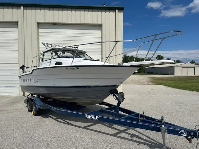 Slide: The Image of 1995 Bayliner Trophy boat on trailer outside a storage facility. - 3