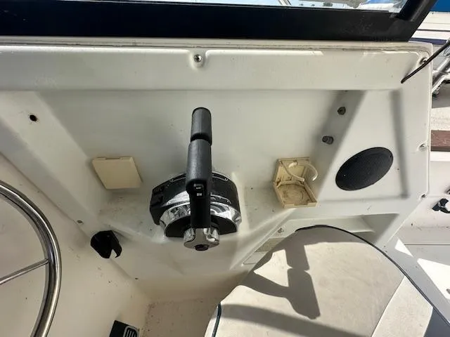 Slide: The Image of 1995 Bayliner Trophy boat control panel with steering wheel and throttle lever. - 9