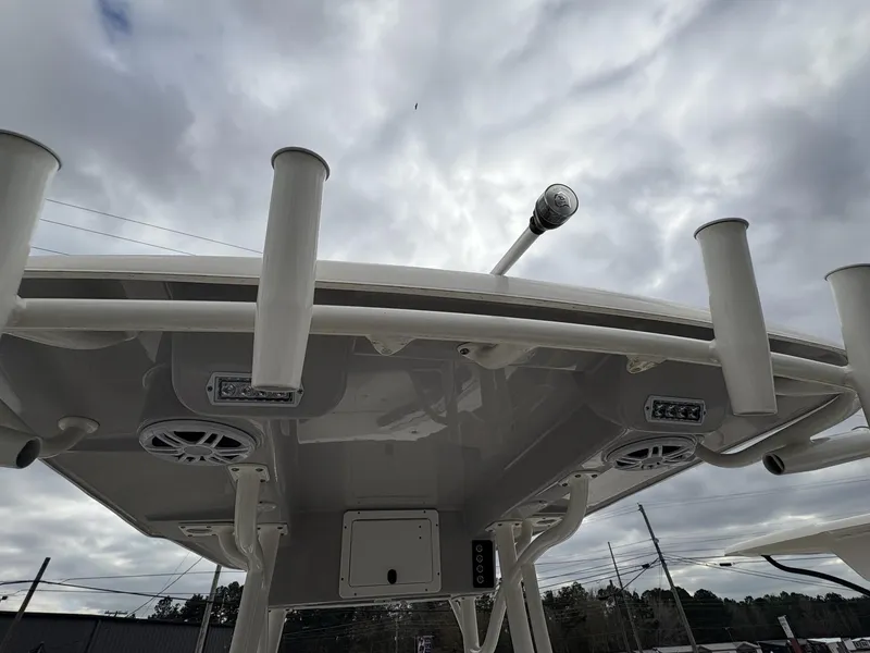Slide: The Image of 2023 Sea Born LX22 boat top view with rod holders and speakers under cloudy sky. - 12