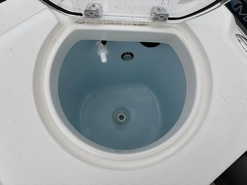 Slide: The Image of 2023 Sea Born LX22 livewell with open lid, showcasing interior water and fittings. - 13