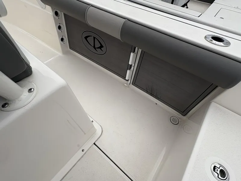 Slide: The Image of 2023 Sea Born LX22 boat interior with storage compartments and rod holders. - 9